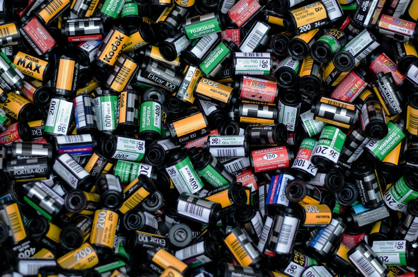 A heap of colorful 35mm film canisters