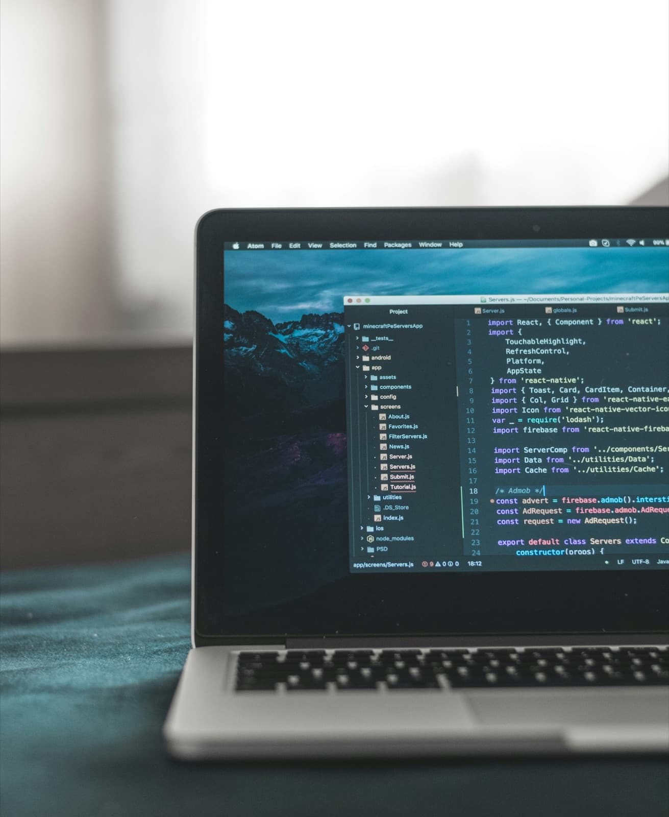 A laptop showing code in a dark editor